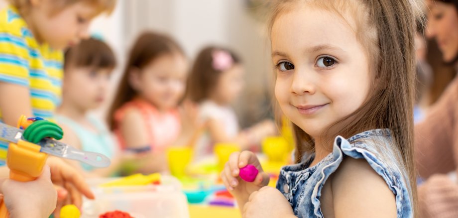 happy kids doing arts and crafts in day care centre