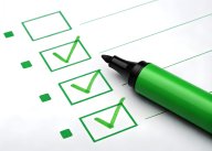 Green marker ticking off items on a checklist with check boxes