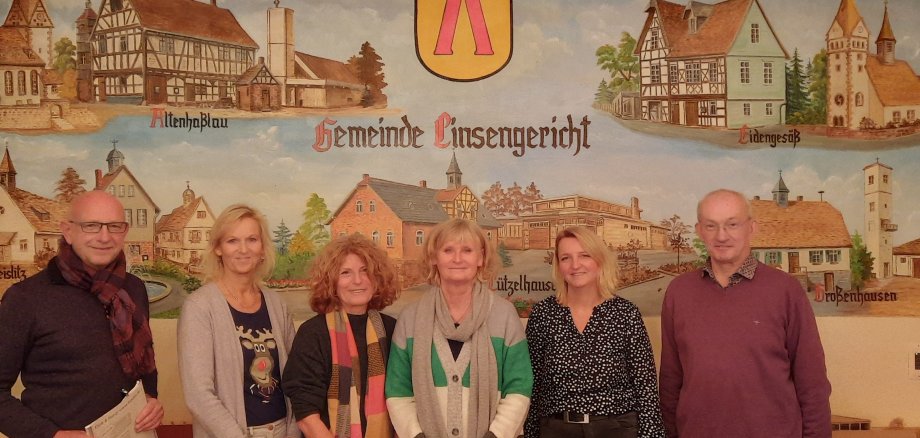 Die Jury des Fotowettbewerbs  vor einem Wandbild in der Zehntscheune am Rathaus Altenhaßlau